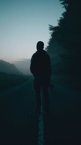 Preview wallpaper man, alone, road, fog, dusk, dark