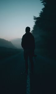 Preview wallpaper man, alone, road, fog, dusk, dark