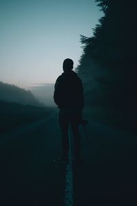 Preview wallpaper man, alone, road, fog, dusk, dark