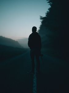 Preview wallpaper man, alone, road, fog, dusk, dark