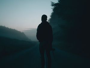 Preview wallpaper man, alone, road, fog, dusk, dark