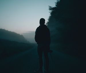 Preview wallpaper man, alone, road, fog, dusk, dark