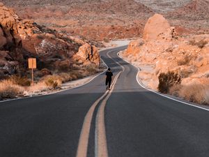 Preview wallpaper man, alone, road, desert, mountains