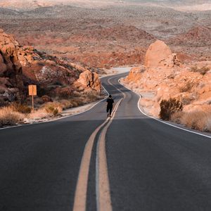 Preview wallpaper man, alone, road, desert, mountains