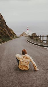 Preview wallpaper man, alone, road, asphalt, lighthouse