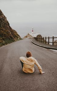 Preview wallpaper man, alone, road, asphalt, lighthouse