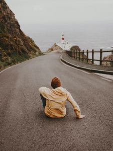 Preview wallpaper man, alone, road, asphalt, lighthouse
