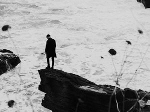 Preview wallpaper man, alone, rock, sea, waves, bw