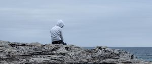 Preview wallpaper man, alone, sad, rock, sea