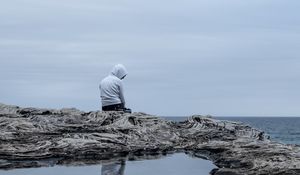 Preview wallpaper man, alone, sad, rock, sea