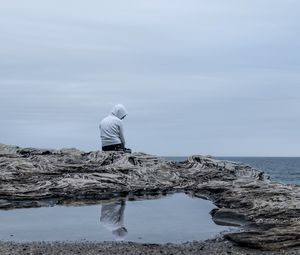 Preview wallpaper man, alone, sad, rock, sea