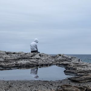 Preview wallpaper man, alone, sad, rock, sea