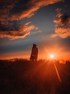 Preview wallpaper man, alone, sunset, grass, field, sunlight