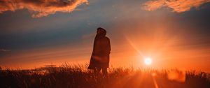 Preview wallpaper man, alone, sunset, grass, field, sunlight