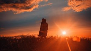 Preview wallpaper man, alone, sunset, grass, field, sunlight