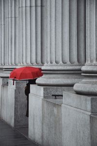 Preview wallpaper man, alone, umbrella, columns, red