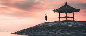 Preview wallpaper man, alone, water, gazebo, shore, sunset