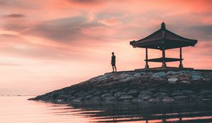 Preview wallpaper man, alone, water, gazebo, shore, sunset