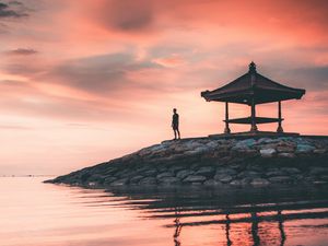 Preview wallpaper man, alone, water, gazebo, shore, sunset