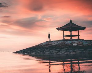 Preview wallpaper man, alone, water, gazebo, shore, sunset