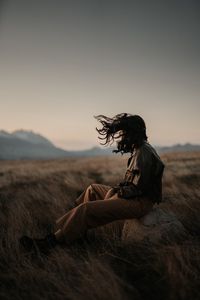 Preview wallpaper man, alone, wind, hair, grass