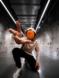 Preview wallpaper man, anonymous, hood, spiral, gesture, sneakers