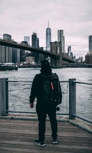 Preview wallpaper man, backpack, cap, bridge