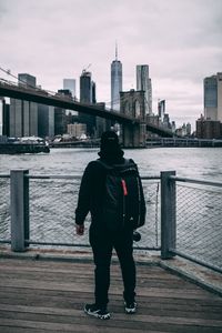 Preview wallpaper man, backpack, cap, bridge