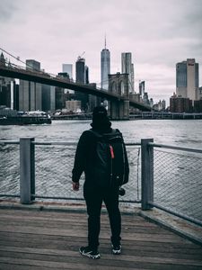 Preview wallpaper man, backpack, cap, bridge