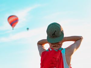 Preview wallpaper man, balloons, sky, cap, backpack