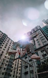 Preview wallpaper man, basketball hoop, sunlight, buildings, flare