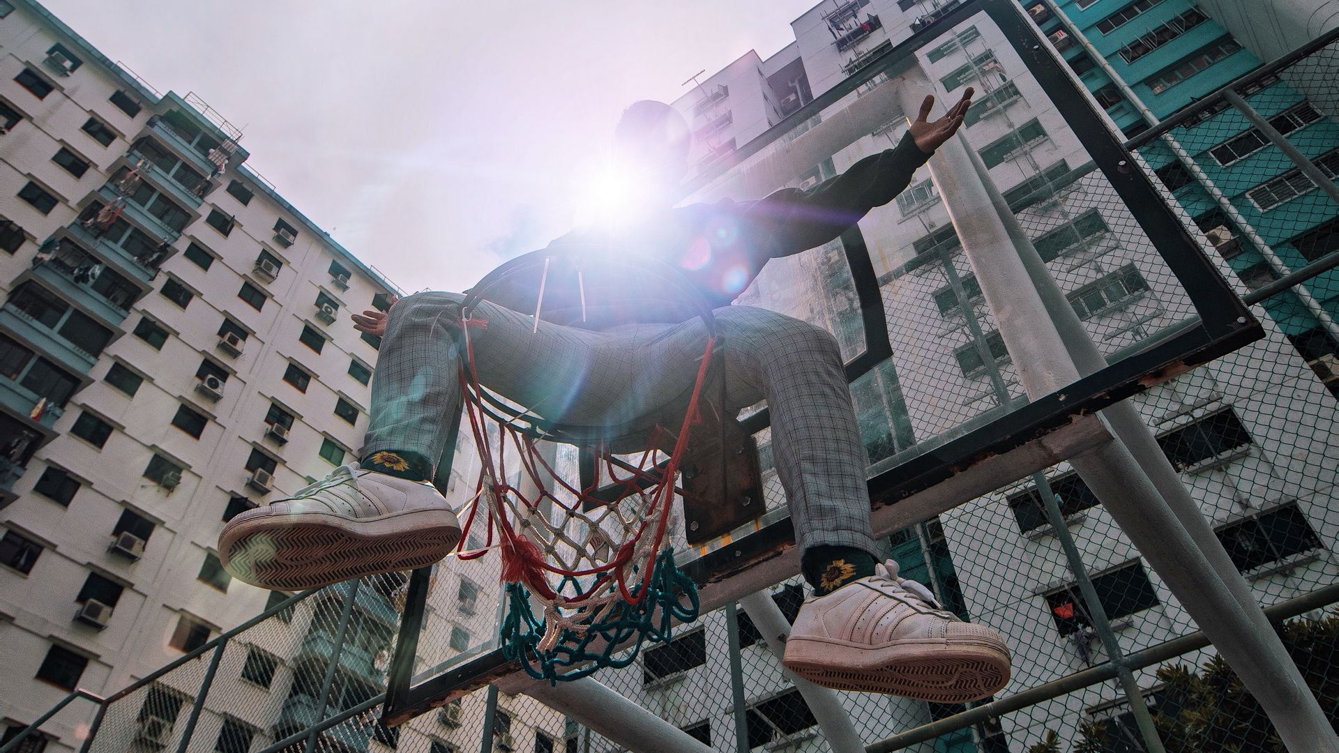 Download wallpaper 1920x1080 man, basketball hoop, sunlight, buildings ...