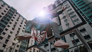 Preview wallpaper man, basketball hoop, sunlight, buildings, flare