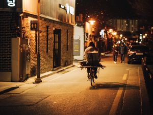 Preview wallpaper man, bike, courier, street, lights, night