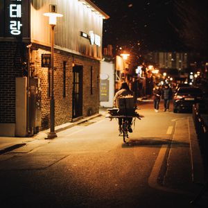 Preview wallpaper man, bike, courier, street, lights, night