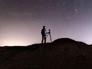 Preview wallpaper man, camera, starry sky, night, dark