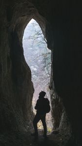 Preview wallpaper man, cave, dark, rock, nature