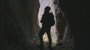 Preview wallpaper man, cave, dark, rock, nature