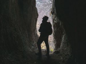 Preview wallpaper man, cave, dark, rock, nature