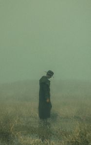 Preview wallpaper man, cloak, hat, field, fog, dark, art