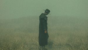 Preview wallpaper man, cloak, hat, field, fog, dark, art