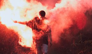 Preview wallpaper man, colored smoke, smoke, night, rain