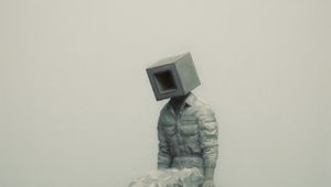 Preview wallpaper man, cube, pose, hill, grass, art