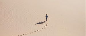 Preview wallpaper man, desert, aerial view, sand, footprints