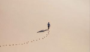 Preview wallpaper man, desert, aerial view, sand, footprints