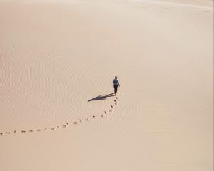 Preview wallpaper man, desert, aerial view, sand, footprints