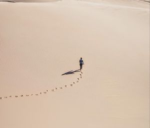 Preview wallpaper man, desert, aerial view, sand, footprints