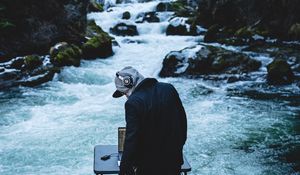 Preview wallpaper man, dj, headphones, river, stones, music