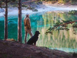 Preview wallpaper man, dog, lake, nature, walk