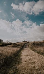 Preview wallpaper man, field, path, sky, clouds